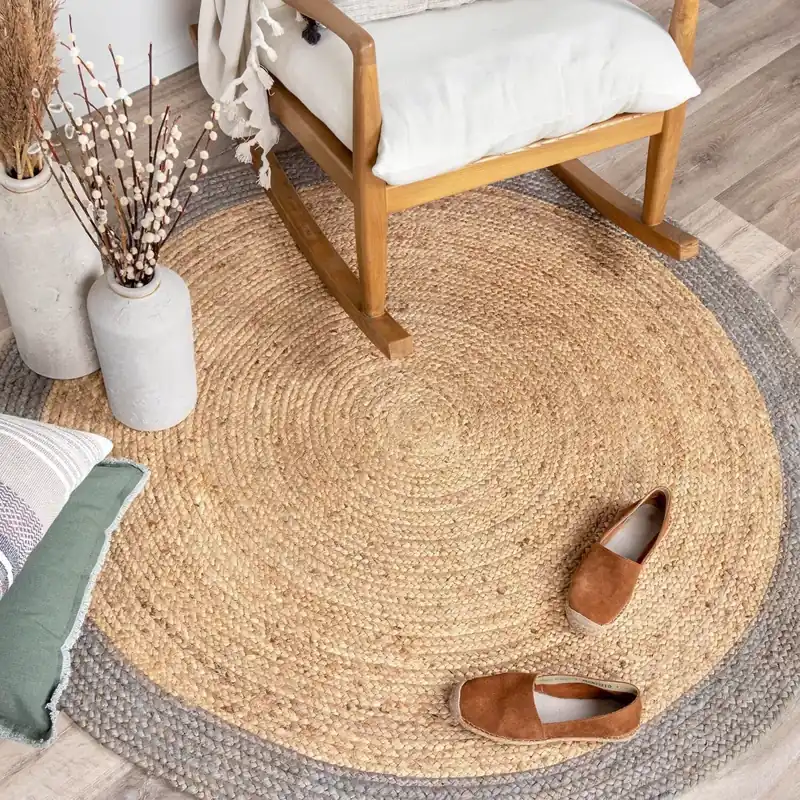 A-round-jute-rug-with-a-braided-border-placed-in-a-living-room-setting